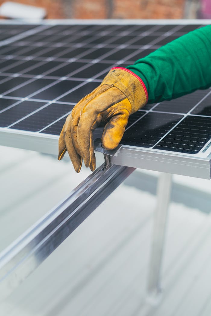 Persons Hand on Top of Solar Panel